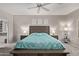 Neutral bedroom with a wooden bed frame, a ceiling fan, and two nightstands at 16803 N 49Th Way, Scottsdale, AZ 85254