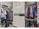 Spacious walk-in closet featuring custom shelving, drawers, and ample hanging space for organized storage at 16803 N 49Th Way, Scottsdale, AZ 85254