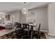 Bright dining room with a decorative light fixture over a dark wooden table and seating for six at 16803 N 49Th Way, Scottsdale, AZ 85254