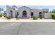Charming home featuring a stucco exterior, arched entryway, and a well-maintained front yard at 16803 N 49Th Way, Scottsdale, AZ 85254
