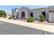 Charming home featuring a stucco exterior, arched entryway, and a well-maintained front yard at 16803 N 49Th Way, Scottsdale, AZ 85254