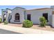 Charming home featuring a stucco exterior, arched entryway, and a well-maintained front yard at 16803 N 49Th Way, Scottsdale, AZ 85254
