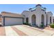 Inviting home featuring a tile roof, arched entryway, and a two-car garage at 16803 N 49Th Way, Scottsdale, AZ 85254