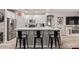 Open kitchen with white cabinetry, stainless steel appliances, and a quartz countertop breakfast bar at 16803 N 49Th Way, Scottsdale, AZ 85254