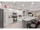 Modern kitchen features stainless steel appliances, white cabinetry, and a quartz countertop breakfast bar with seating at 16803 N 49Th Way, Scottsdale, AZ 85254
