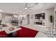 Bright living room with wood floors, ceiling fan, a fireplace and open layout to kitchen at 16803 N 49Th Way, Scottsdale, AZ 85254
