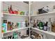 Walk-in pantry is well stocked and organized with a variety of food and beverage items on multiple shelves at 16803 N 49Th Way, Scottsdale, AZ 85254