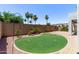 Backyard putting green surrounded by desert landscaping and mature palm trees at 16803 N 49Th Way, Scottsdale, AZ 85254