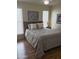 Bedroom featuring a large bed, window blinds, and laminate wood floor at 1725 N Date -- # 8, Mesa, AZ 85201