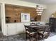 This dining room has a wood accent wall with a kitchenette and a modern light fixture at 1725 N Date -- # 8, Mesa, AZ 85201