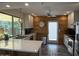 Bright kitchen with white cabinets, stainless appliances, quartz countertops, and an adjacent dining area at 1725 N Date -- # 8, Mesa, AZ 85201