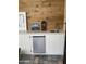 This kitchenette features white cabinets, mini-fridge, wood backsplash, and a small sink at 1725 N Date -- # 8, Mesa, AZ 85201