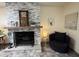 Cozy living room with a stone fireplace and comfortable seating, creating an inviting atmosphere at 1725 N Date -- # 8, Mesa, AZ 85201