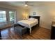 Bright main bedroom featuring a large bed, seating, and french doors that lead to the pool area at 1725 N Date -- # 8, Mesa, AZ 85201