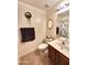 Cozy bathroom featuring a single sink vanity, toilet, and shower with decorative accents at 17257 W Papago St, Goodyear, AZ 85338