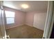 Neutral bedroom offering a window for natural light and closet space at 17257 W Papago St, Goodyear, AZ 85338