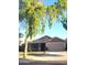Charming single-story home with a well-maintained lawn and mature shade trees at 17257 W Papago St, Goodyear, AZ 85338