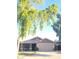 Charming single-story home with a two-car garage and mature trees enhancing curb appeal at 17257 W Papago St, Goodyear, AZ 85338