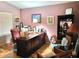 Traditional home office featuring a large wooden desk, hardwood floors, and soft ambient lighting at 17257 W Papago St, Goodyear, AZ 85338