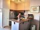 Cozy kitchen features wood cabinetry, a stainless steel refrigerator, and a breakfast bar at 17257 W Papago St, Goodyear, AZ 85338