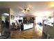 Open-concept living room boasts hardwood floors, a ceiling fan, and an entertainment center at 17257 W Papago St, Goodyear, AZ 85338