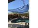 Inviting swimming pool with a shade awning, rock features, and manicured landscaping at 17257 W Papago St, Goodyear, AZ 85338