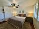 Relaxing bedroom with a ceiling fan, neutral colors, bedside tables, and soft lamps at 1742 W Butler Dr, Phoenix, AZ 85021