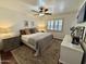 Comfortable bedroom with ceiling fan, plantation shutters, soft lighting, and neutral decor at 1742 W Butler Dr, Phoenix, AZ 85021