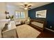 Bright Bedroom featuring a dark wood crib, shutters, and accent wall at 1742 W Butler Dr, Phoenix, AZ 85021
