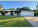 Charming single-story home featuring a well-manicured lawn and a two-car garage at 1742 W Butler Dr, Phoenix, AZ 85021