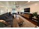 Cozy living room with hardwood floors, a comfortable sofa, and a large flat-screen TV at 1742 W Butler Dr, Phoenix, AZ 85021