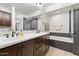 Luxurious bathroom featuring a soaking tub, glass-enclosed shower, and dual vanity at 17850 N 68Th St # 1017, Phoenix, AZ 85054