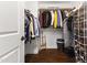 Spacious walk-in closet with shelving, clothing rods and hardwood floors for storing and organizing personal items at 17850 N 68Th St # 1017, Phoenix, AZ 85054
