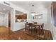 Elegant dining area with stylish chandelier, classic rug, and access to a modern kitchen at 17850 N 68Th St # 1017, Phoenix, AZ 85054