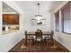Elegant dining area with stylish chandelier, classic rug, and access to a modern kitchen at 17850 N 68Th St # 1017, Phoenix, AZ 85054