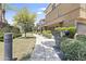 Beautifully landscaped walkway leading to tan multi-story townhome exteriors on a sunny day at 17850 N 68Th St # 1017, Phoenix, AZ 85054