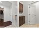 Hallway with tile flooring, cabinet, and an open doorway leading to a walk-in closet, providing ample storage space at 17850 N 68Th St # 1017, Phoenix, AZ 85054