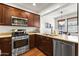 Modern kitchen with stainless steel appliances, wood cabinets, and a functional layout for easy cooking at 17850 N 68Th St # 1017, Phoenix, AZ 85054