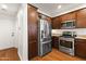 Modern kitchen with stainless steel appliances, wood cabinets, and ample storage at 17850 N 68Th St # 1017, Phoenix, AZ 85054