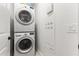 Laundry room with stacked washer and dryer units plus a wall mounted control panel, offering convenience at 17850 N 68Th St # 1017, Phoenix, AZ 85054