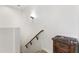 Bright stairway featuring a wooden handrail and traditional wall sconce for a warm and inviting ambiance at 17850 N 68Th St # 1017, Phoenix, AZ 85054