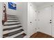 Well-lit stairway features wood treads, white risers, and runner, leading to the upper level at 17850 N 68Th St # 1017, Phoenix, AZ 85054