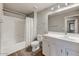 Bright bathroom features a tub with shower, white vanity, and wood-look tile flooring at 20100 N 78Th Pl # 2019, Scottsdale, AZ 85255