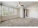 Bright bedroom featuring plush carpet, ceiling fan, and abundant natural light through shuttered windows at 20100 N 78Th Pl # 2019, Scottsdale, AZ 85255