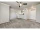 Spacious living room featuring neutral paint, carpet and ceiling fan with views into kitchen at 20100 N 78Th Pl # 2019, Scottsdale, AZ 85255
