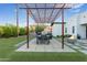 Backyard with outdoor kitchen and grill area with a fire pit, and modern pergola at 2215 N 38Th Way, Phoenix, AZ 85008