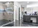Bathroom features a glass enclosed shower, gray vanity, and tiled floors at 2215 N 38Th Way, Phoenix, AZ 85008