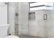 Modern bathroom with sleek tile shower featuring built-in niche and matte black hardware at 2215 N 38Th Way, Phoenix, AZ 85008