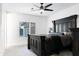 Bedroom with ceiling fan, large window, and a black, king sized bed at 2215 N 38Th Way, Phoenix, AZ 85008