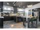 Modern kitchen featuring sleek black cabinetry, stainless steel appliances, an island, and polished concrete floors at 2215 N 38Th Way, Phoenix, AZ 85008